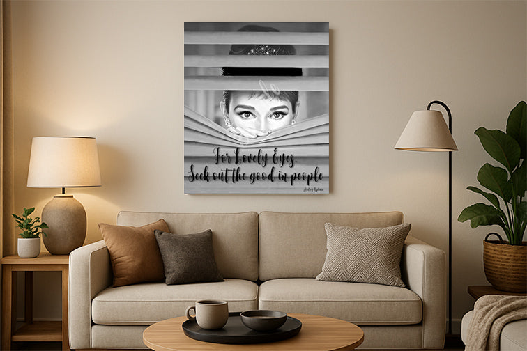 Living room with a beige sofa, coffee table, and wall art featuring a black and white portrait.